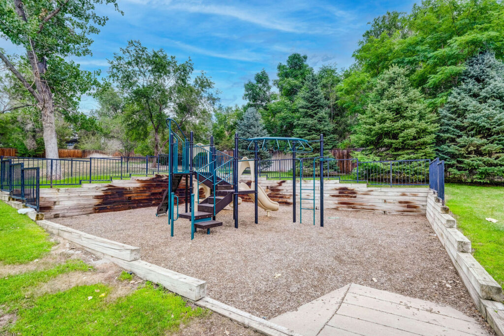 Playground with climbing and slides, mulched bed underneath.