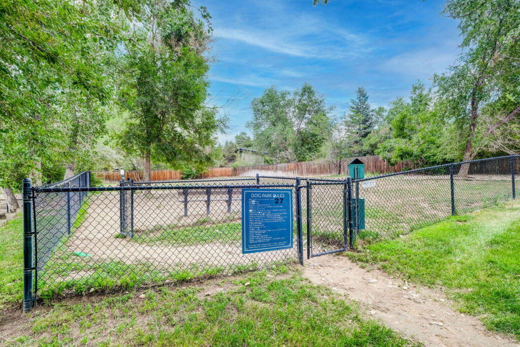 Fenced dog park with benches and waste stations