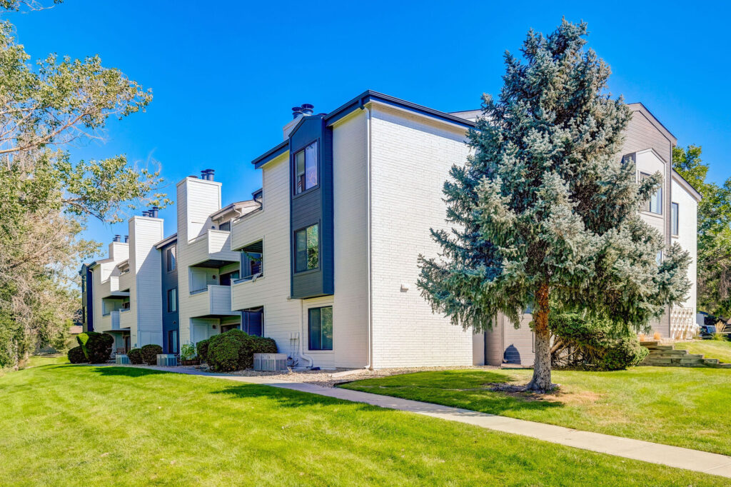 Exterior view of residential building with trees and sidewalk