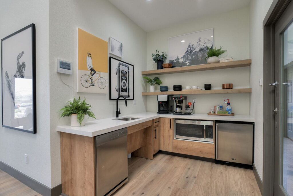 Clubhouse kitchen area with sink, coffee maker, mini fridge, microwave, and dishwasher.