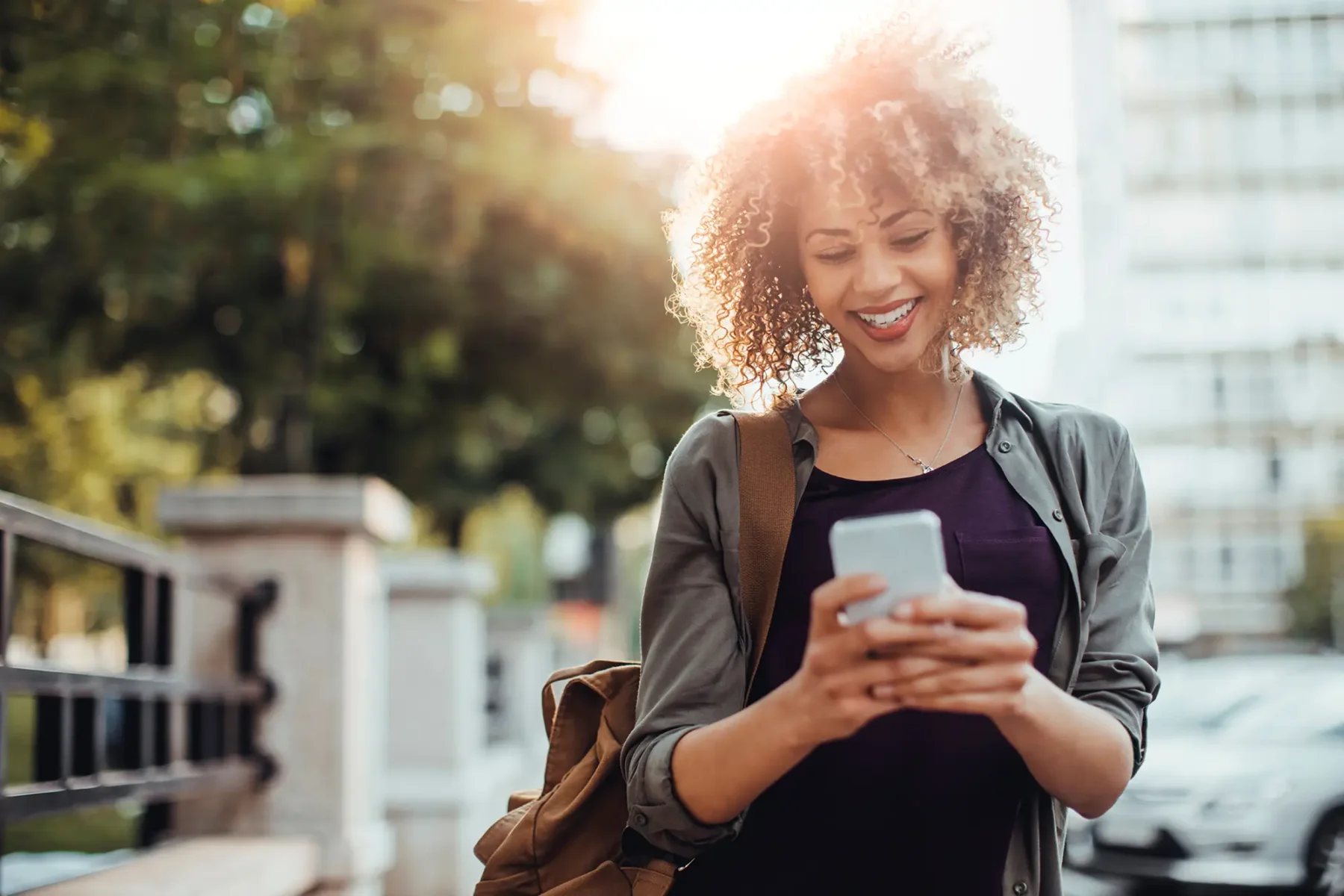 Young woman smiling at her phone