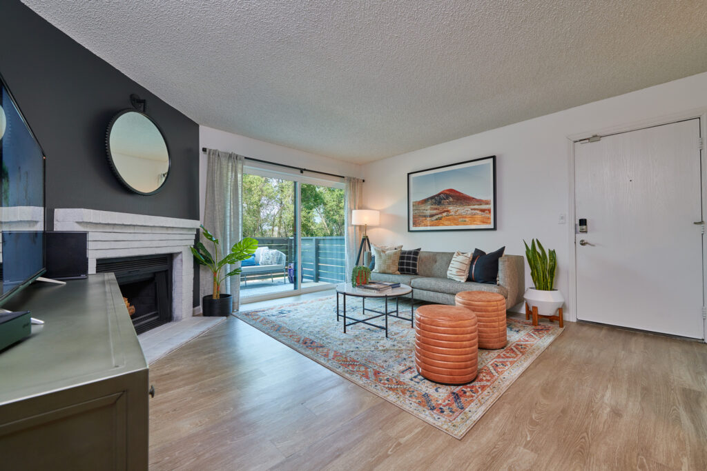 Furnished living room with fire place and patio doors at Greenwood Point Englewood apartments